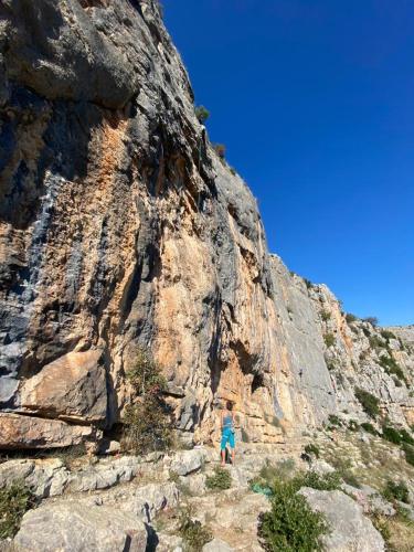 a person is walking up a rocky mountain at Krka Ivan in Lozovac