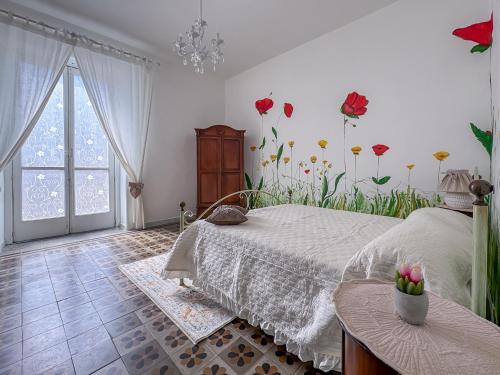 a bedroom with a bed and flowers on the wall at Franci House in Sant'Agnello