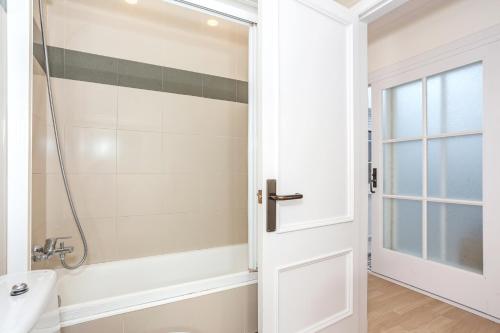baño con ducha y puerta blanca en Preciosas vistas en Es Grau, en Es Grau