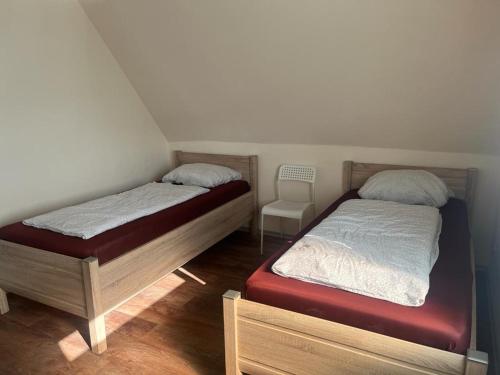 two twin beds in a room with at Pension Highway Bielefeld Senner Hellweg in Bielefeld
