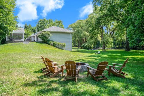 a group of chairs and a table in the grass at Lily Pond Haven - Private Hot tub - Large recently remodeled home! in Glenn