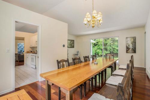 a dining room with a wooden table and chairs at Lily Pond Haven - Private Hot tub - Large recently remodeled home! in Glenn