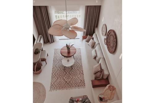 a living room with a ceiling fan and a table at Pilos Suites in Turunc