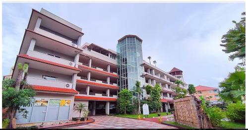 a large apartment building with a tall building at Gazebo Resort, Pattaya in Pattaya