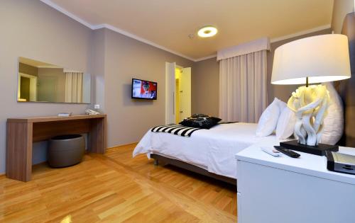 a hotel room with a bed and a desk with a lamp at Luxe apartment Del Mare in Podstrana