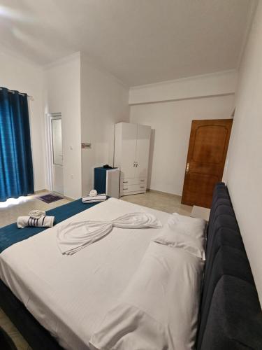 a bedroom with a large white bed in a room at DEA Room 1 in Sarandë