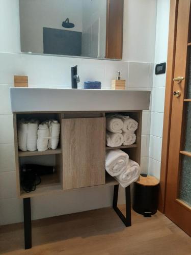 a bathroom with a sink and towels under it at Mami Home Milano Con parcheggio tax1euro in Cormano