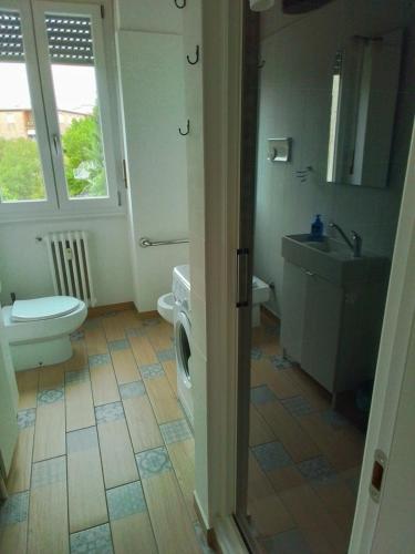 a bathroom with a toilet sink and a washing machine at P&P Bergamo Apartment in Bergamo