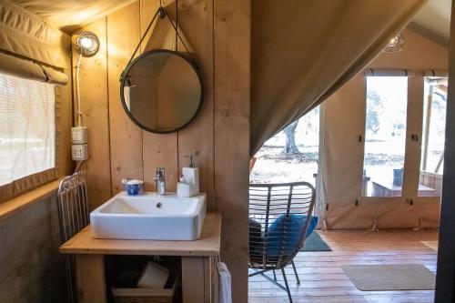 a bathroom with a sink and a mirror at Domus Olea Glamping in Ceglie Messapica