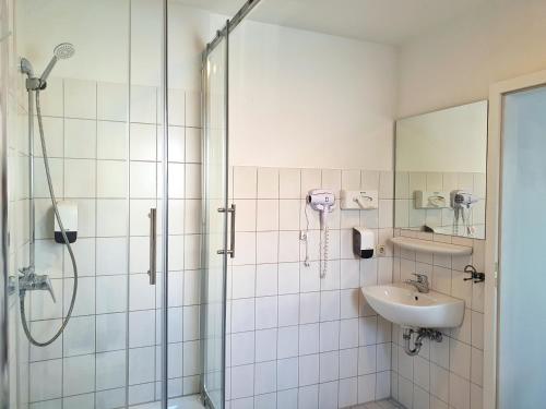 a bathroom with a shower and a sink at Aparthotel B & L in Bremen