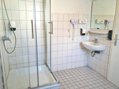 a bathroom with a shower and a sink at Aparthotel B & L in Bremen