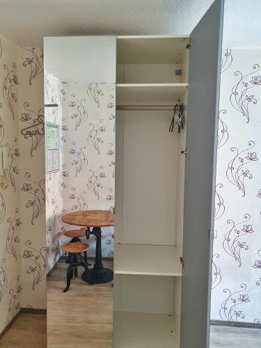 a room with a table and a stool in a room at Aparthotel B & L in Bremen