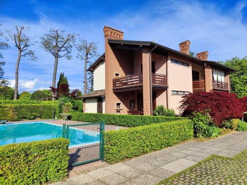 a house with a swimming pool in front of it at Apartment Karol in Manerba del Garda