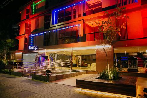 a building with colorful lights on it at night at Unity #421 - Praia de Cabo branco por Carpediem in Penha