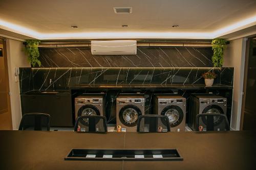 a laundry room with washers and dryers in it at Unity #421 - Praia de Cabo branco por Carpediem in Penha