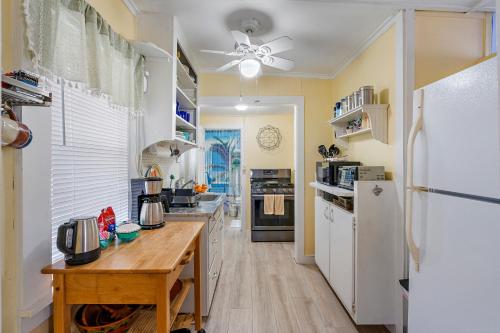 a kitchen with a white refrigerator and a wooden counter at Little Pineapple Cottage in St. Petersburg