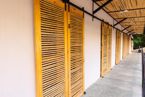 a row of wooden shutters on the side of a building at Hotel Casa de Hadas in Minca