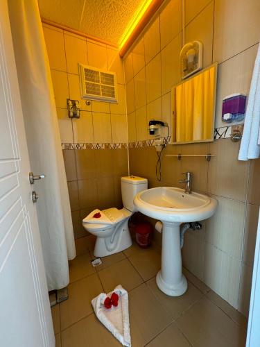 a bathroom with a sink and a toilet at Far Life Hotel in Antalya