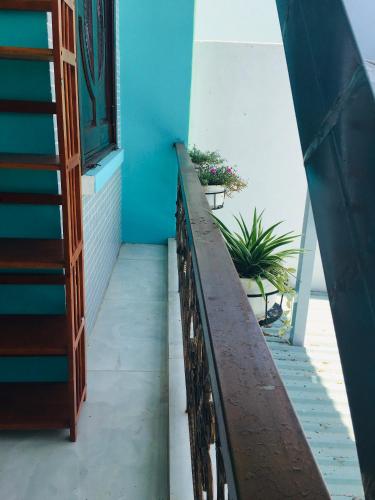 a stairway in a house with a blue wall at SEA HOME HOMESTAY in Ấp Bình Hưng