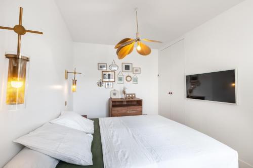 a bedroom with two beds and a flat screen tv at Superbe maison d'architecte familiale près de Paris in Gentilly