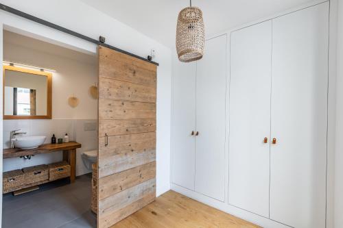 - une porte coulissante dans la salle de bains pourvue d'un lavabo dans l'établissement Superbe maison d'architecte familiale près de Paris, à Gentilly