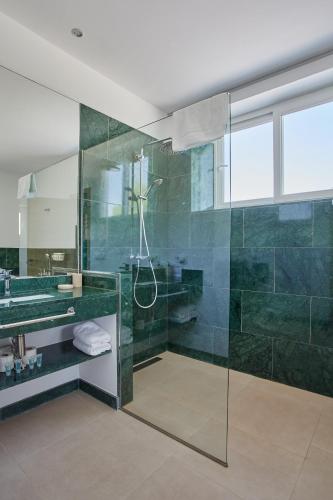 a bathroom with a glass shower and a sink at Finca La Fuensanta in Arcos de la Frontera