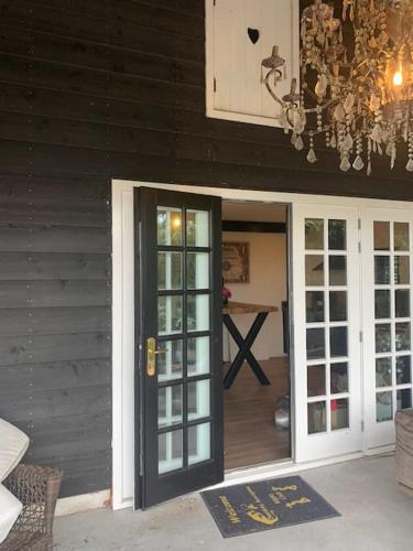 a chandelier is hanging above a door to a house at tuinhuis in Harmelen