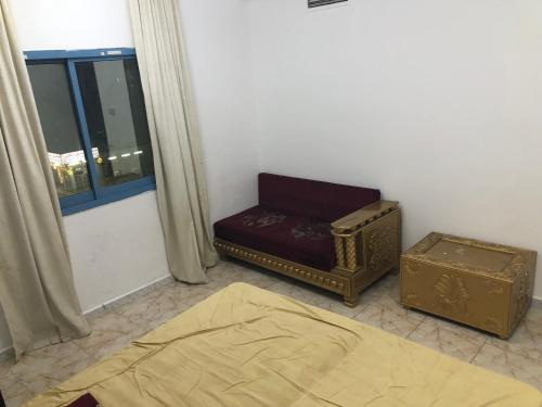 a living room with a couch and a window at Al Majaz King Size Room in Sharjah