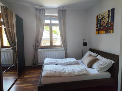 a bed in a room with a large window at Apartament w centrum Brzeska in Brzesko