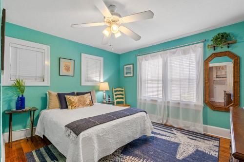 a bedroom with a bed and a ceiling fan at The Pineapple Bungalow St Pete in St Petersburg