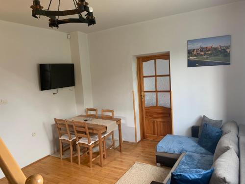 a living room with a couch and a table at Cracow Family House in Kraków