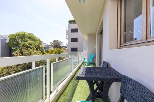 a balcony with a table and chairs on a building at Studio Cap Antibes in Juan-les-Pins