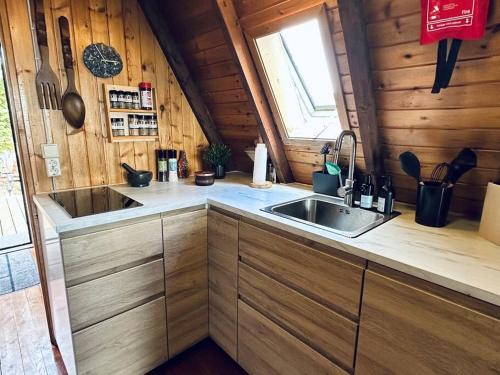 a kitchen with a sink in a wooden cabin at Cozy Cabin in Stunning Nature - Borgarfjordur in Staðarhús
