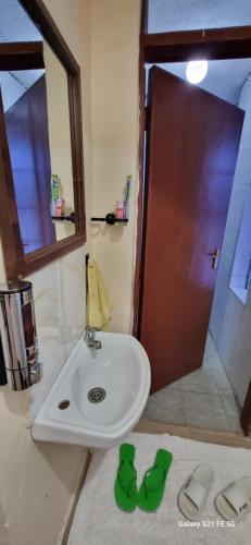 a bathroom with a sink and a mirror at Crystal Cribs Eldoret in Eldoret