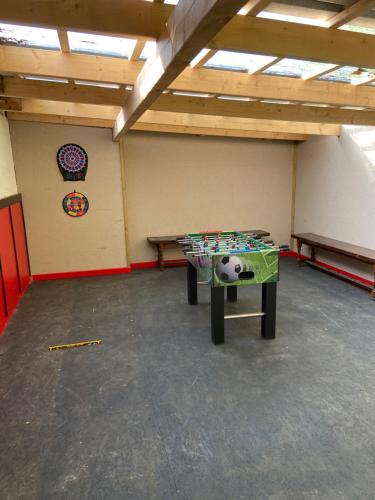 a room with a ping pong table in it at Lütte Uttiet in Stelle-Wittenwurth