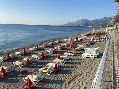 a beach with lounge chairs and the ocean at Far Life Hotel in Antalya