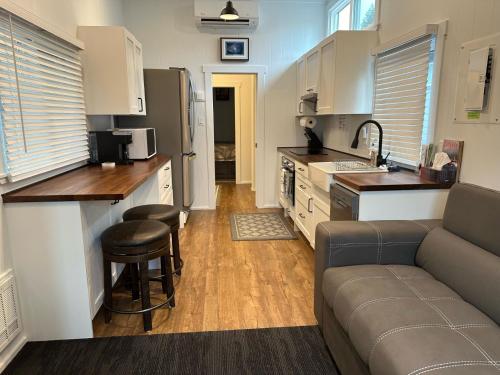 a kitchen and a living room with a couch and a counter at Chims Cabins - Port Alberni in Port Alberni