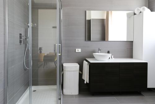 a bathroom with a sink and a glass shower at Heliconia Park Lagos Luxury Apartments in Lagos