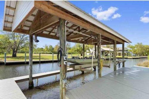 a dock with a boat on the water at Getting Nauti at the Bay in Shoreline Park