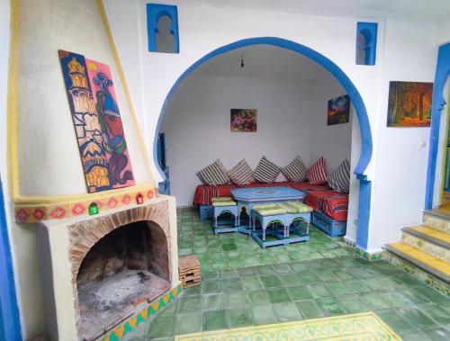 un soggiorno con divano e camino di Casa Mablu a Chefchaouen
