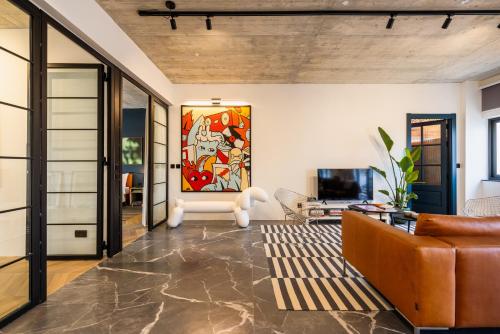 a living room with a couch and a television at Bamboozle Loft in St. Paul's Bay