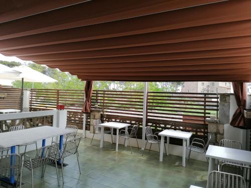 a row of tables and chairs on a patio at Villa Mercè Empúries in Sant Martí d’Empúries