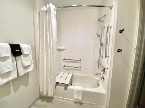 a white bathroom with a shower and a sink at Holiday Inn Express & Suites Elyria by IHG in Elyria