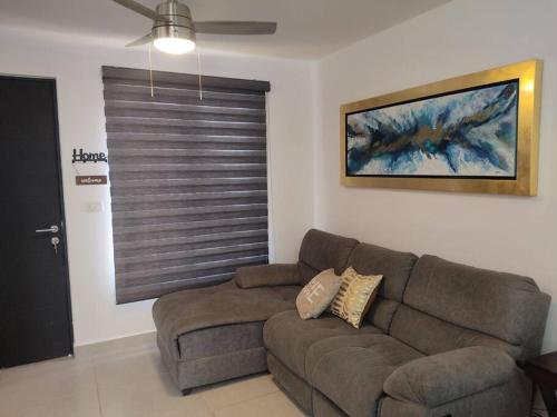 a living room with a couch and a window at Casa confort nueva Cerca de outlets y Hospital Regional in Santa Gertrudis