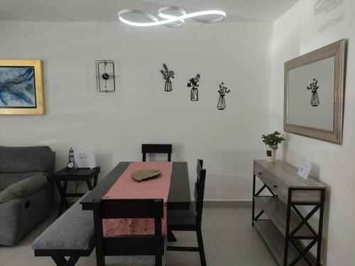 a living room with a table and a table and a couch at Casa confort nueva Cerca de outlets y Hospital Regional in Santa Gertrudis