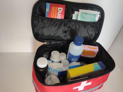a suitcase filled with various items at Casa confort nueva Cerca de outlets y Hospital Regional in Santa Gertrudis