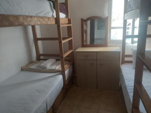 a room with two bunk beds and a mirror at The Sea Guesthouse in Agadir