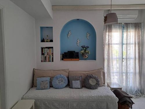 a bedroom with a bed with pillows on it at Faro del mar in Naxos Chora