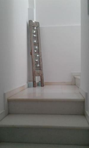a wooden chair sitting on top of some stairs at Faro del mar in Naxos Chora