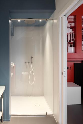 a shower with a glass door in a bathroom at Interno Marche Design Experience Hotel in Tolentino